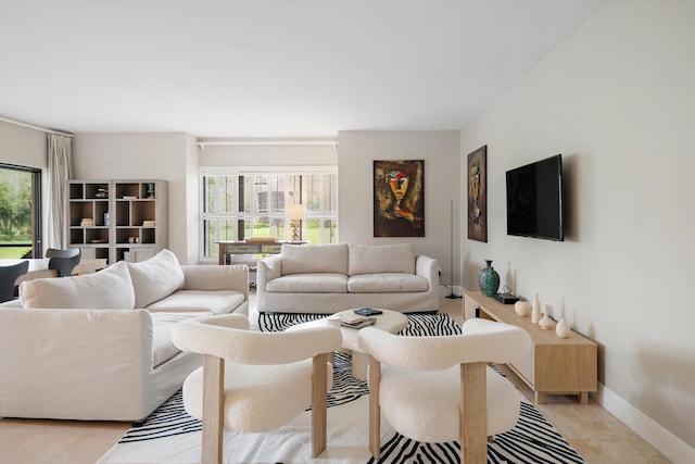 tiled living room featuring a healthy amount of sunlight