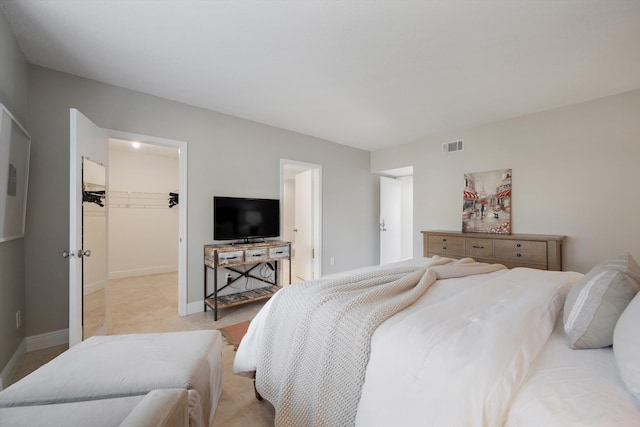 bedroom featuring a walk in closet and a closet