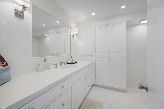 bathroom featuring tasteful backsplash, crown molding, and vanity