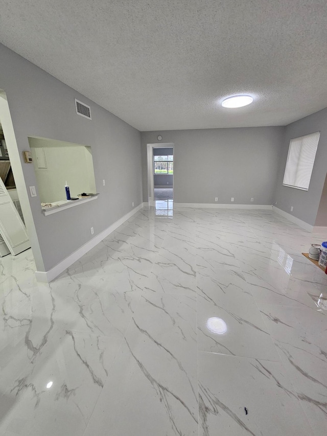 spare room featuring a textured ceiling