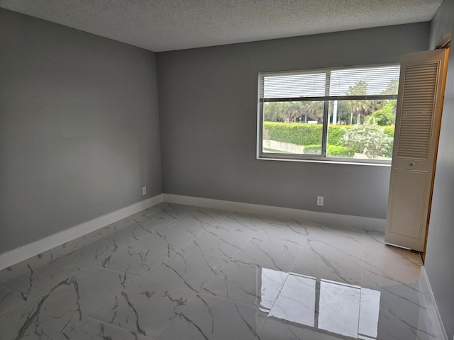 empty room featuring a textured ceiling