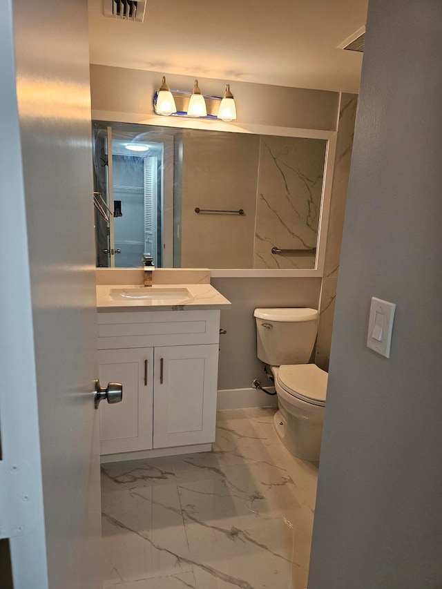 bathroom with toilet and vanity