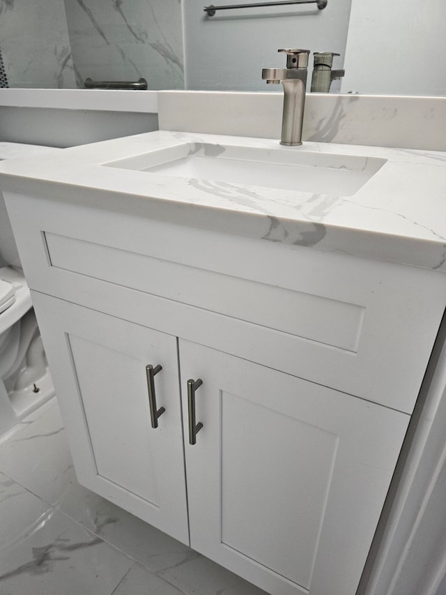 bathroom featuring toilet and vanity