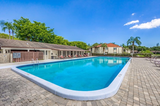 view of swimming pool with a patio