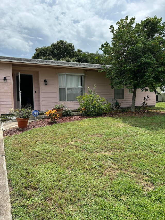 ranch-style house with a front lawn