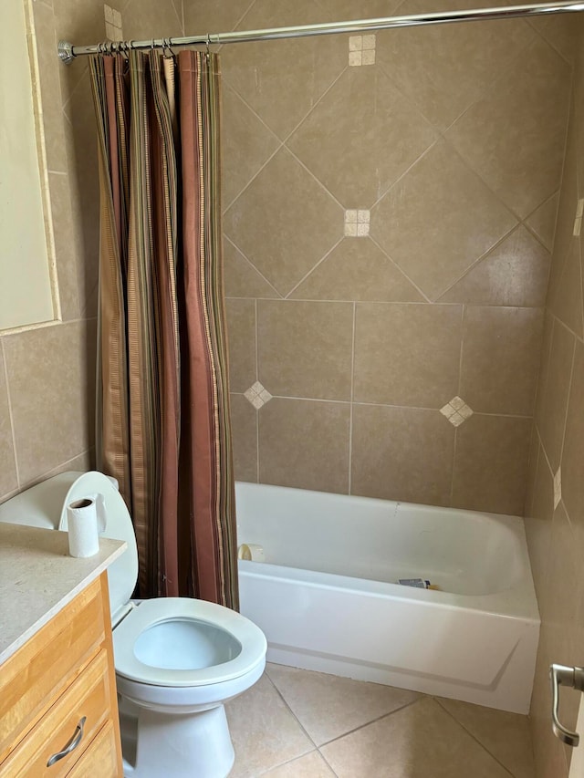 full bathroom featuring shower / bath combo with shower curtain, tile patterned floors, toilet, and vanity