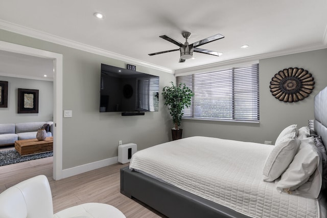 bedroom featuring ceiling fan, crown molding, and light hardwood / wood-style flooring