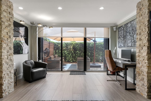 interior space featuring hardwood / wood-style flooring, plenty of natural light, and ornamental molding