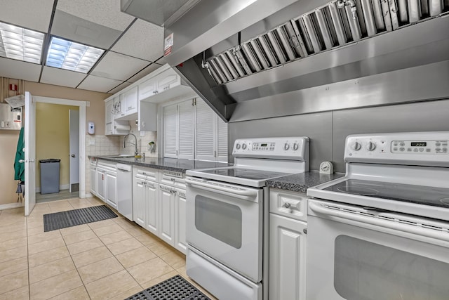 kitchen featuring sink, light tile patterned floors, white appliances, and white cabinetry