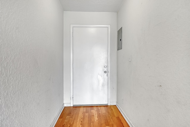 doorway to outside featuring hardwood / wood-style floors and electric panel