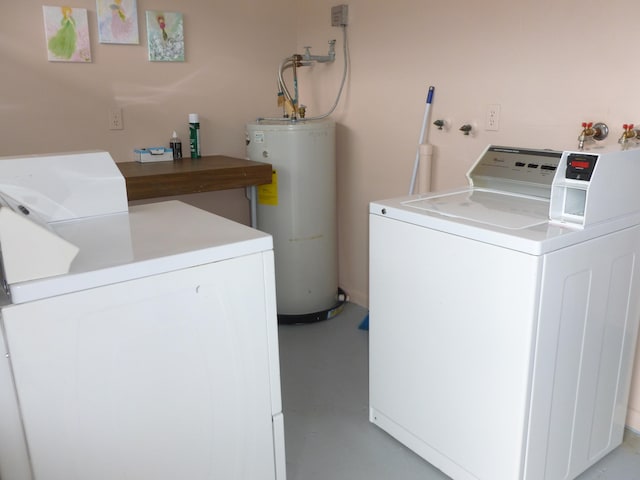 laundry area with separate washer and dryer and water heater