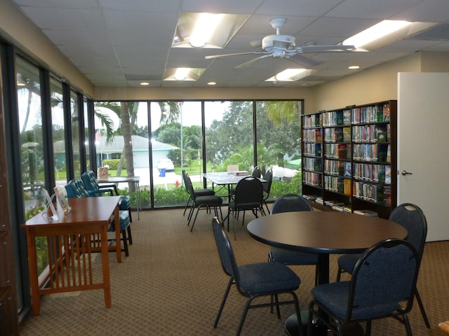 sunroom featuring ceiling fan and a drop ceiling