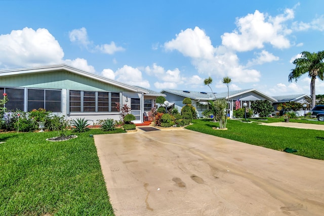 view of front of house with a front yard and driveway