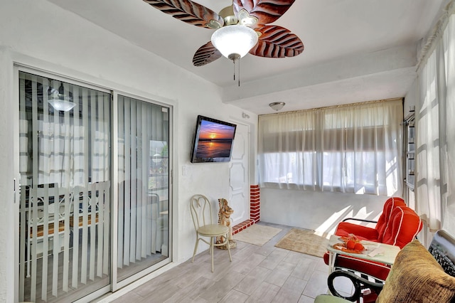 living room with ceiling fan and light hardwood / wood-style floors