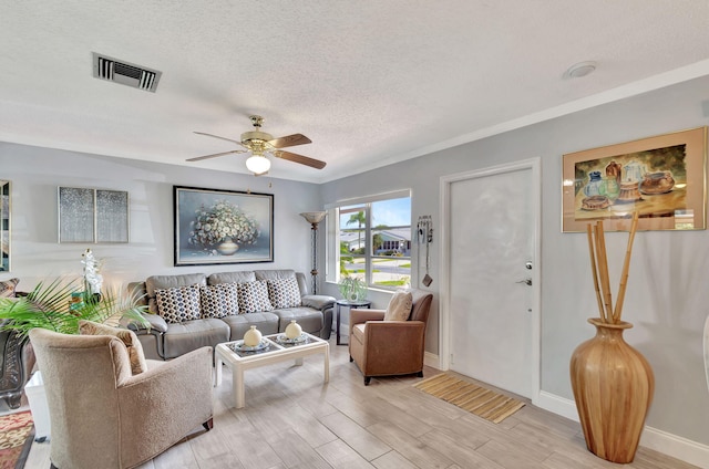 living room with light wood-type flooring, ceiling fan, and a textured ceiling