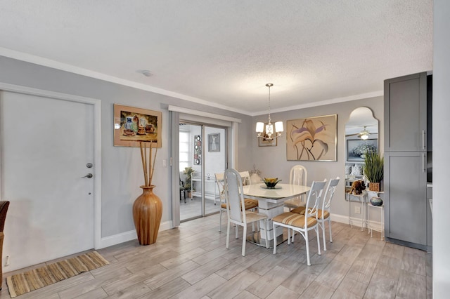 dining space with crown molding, a textured ceiling, ceiling fan with notable chandelier, and light hardwood / wood-style floors