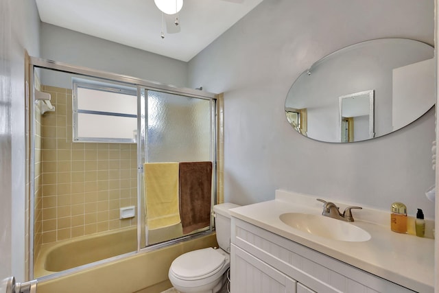 full bathroom featuring shower / bath combination with glass door, vanity, and toilet