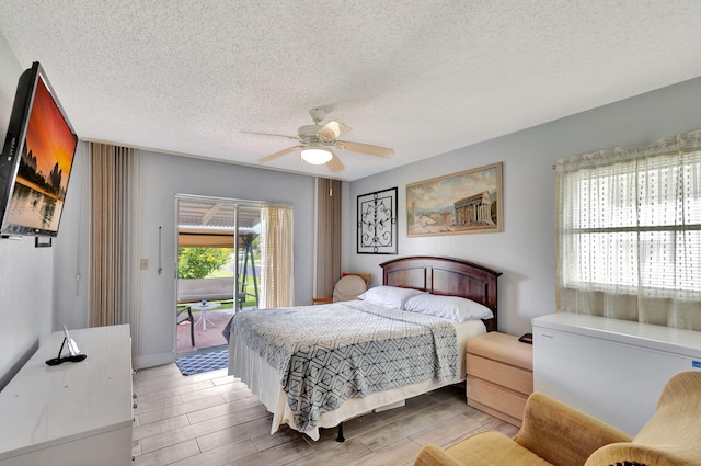 bedroom featuring ceiling fan, light hardwood / wood-style floors, access to outside, and a textured ceiling