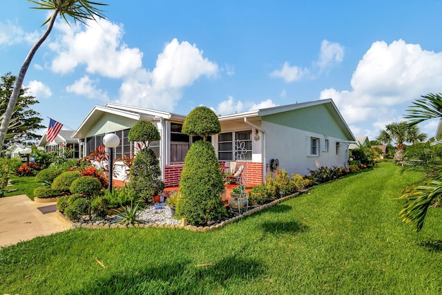 view of side of home with a lawn