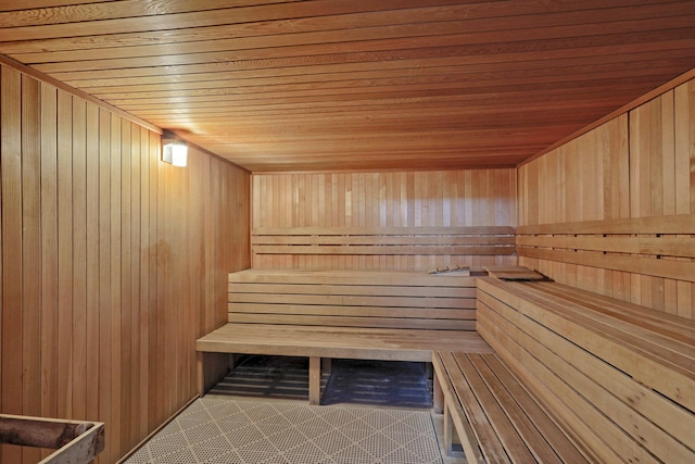 view of sauna featuring wooden walls and wooden ceiling