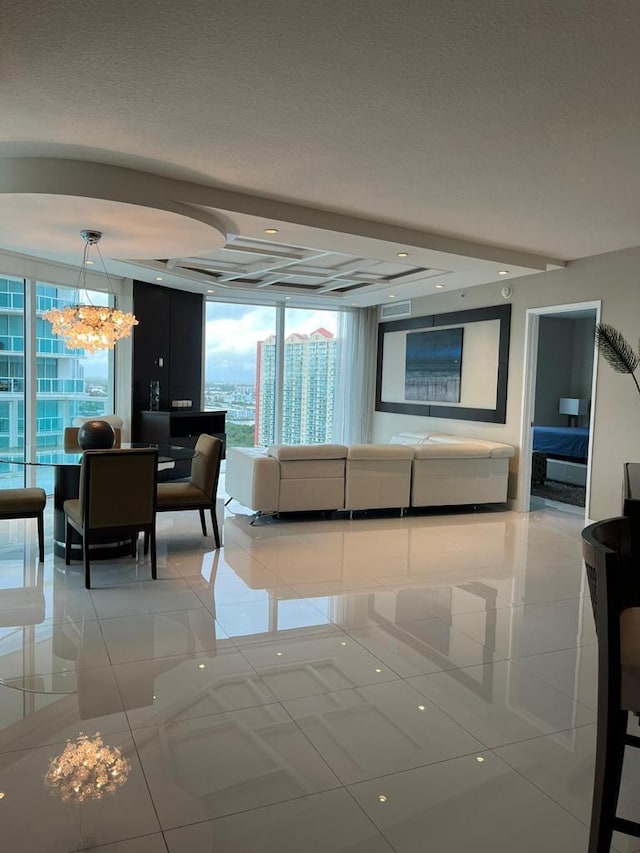 tiled living room with a textured ceiling, a notable chandelier, and a wall of windows