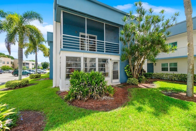 rear view of property with a yard