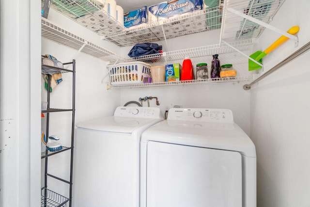 clothes washing area with washing machine and dryer