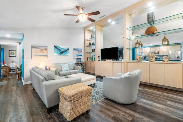 living room with ceiling fan, dark hardwood / wood-style flooring, and vaulted ceiling