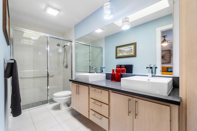 bathroom featuring vanity, toilet, tile patterned floors, and walk in shower