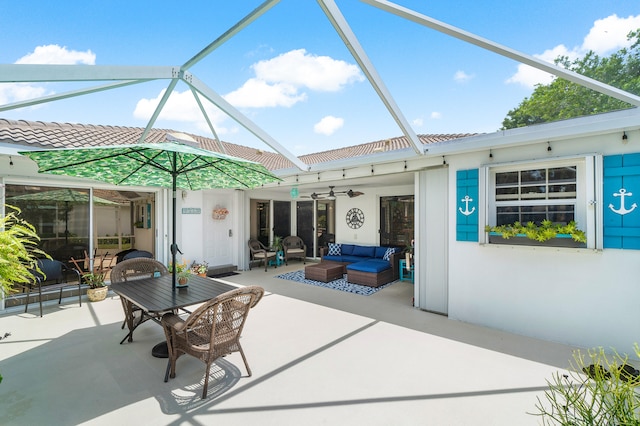 view of patio / terrace with outdoor lounge area, ceiling fan, and a lanai