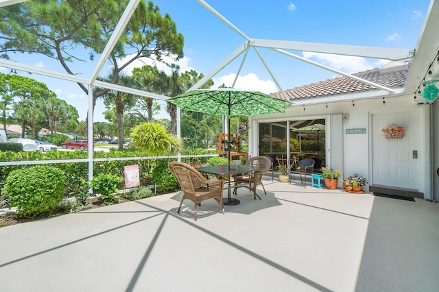 view of patio / terrace featuring glass enclosure