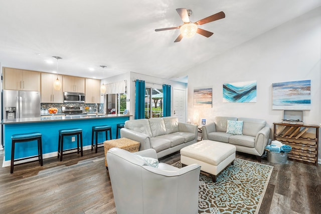 living room featuring ceiling fan, sink, vaulted ceiling, and dark hardwood / wood-style flooring