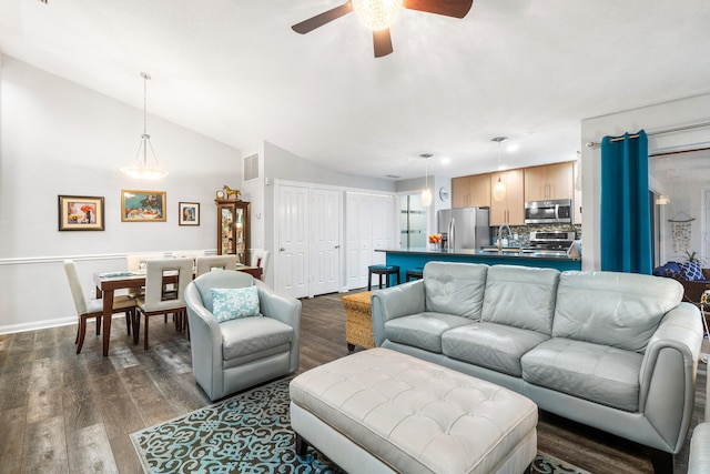 living room with lofted ceiling, dark wood-type flooring, and ceiling fan