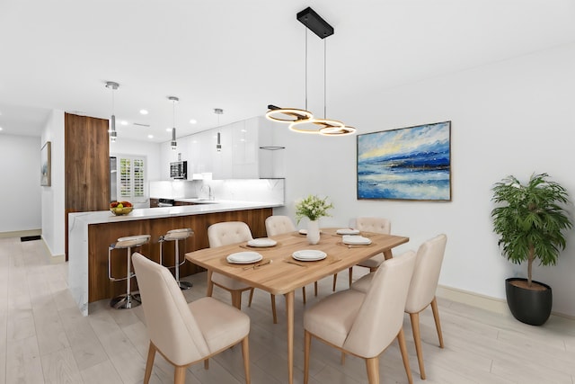 dining room featuring light hardwood / wood-style floors and sink