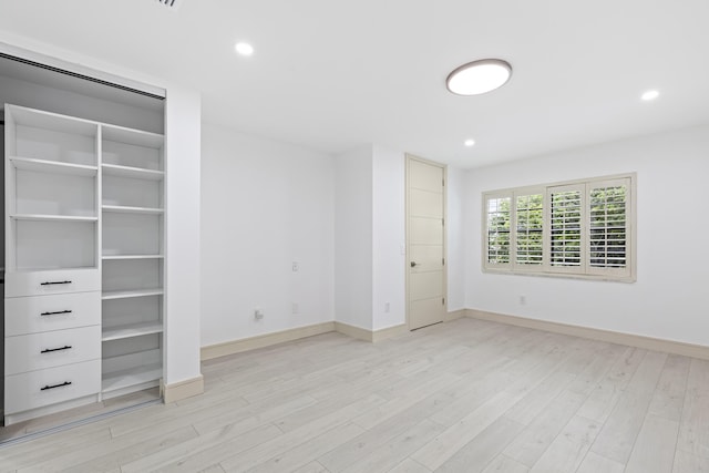 unfurnished bedroom with light wood-type flooring