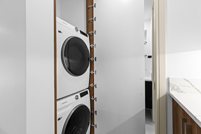 laundry room with stacked washing maching and dryer