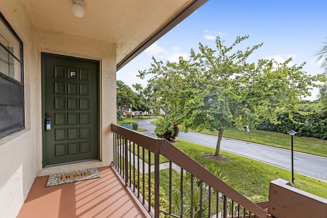 property entrance featuring a lawn