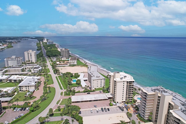 birds eye view of property with a water view and a view of the beach