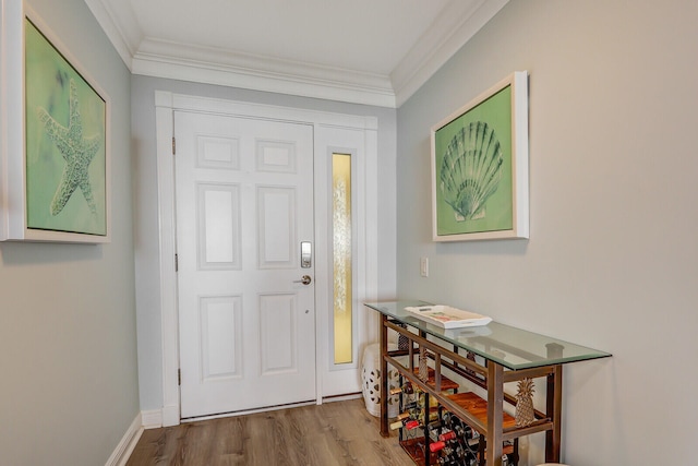 entrance foyer with hardwood / wood-style flooring and ornamental molding