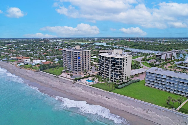 birds eye view of property featuring a beach view and a water view