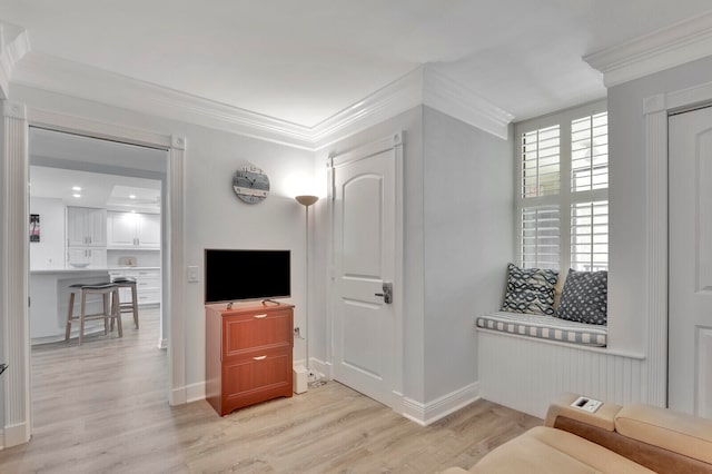 living room with light hardwood / wood-style flooring and ornamental molding