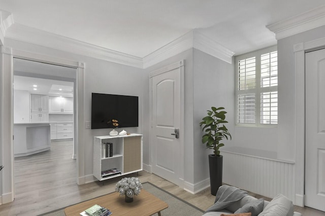 living room with ornamental molding and light wood-type flooring