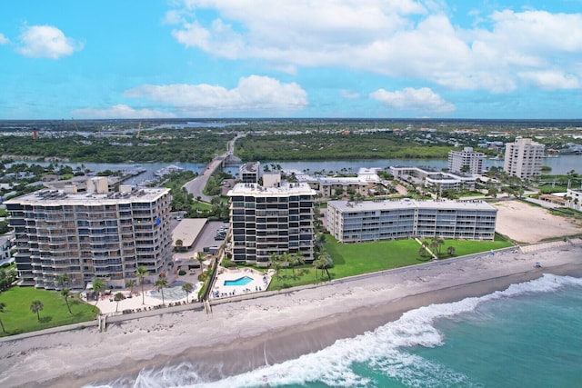 birds eye view of property featuring a water view and a beach view