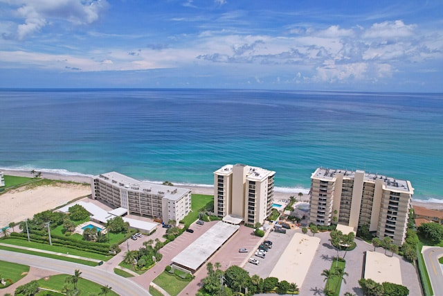 aerial view with a water view and a view of the beach