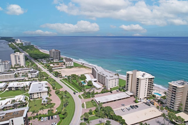 aerial view with a water view and a beach view