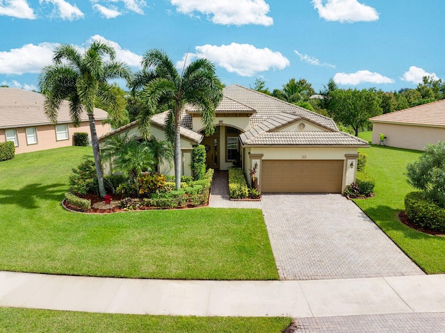 mediterranean / spanish-style home featuring a garage and a front yard