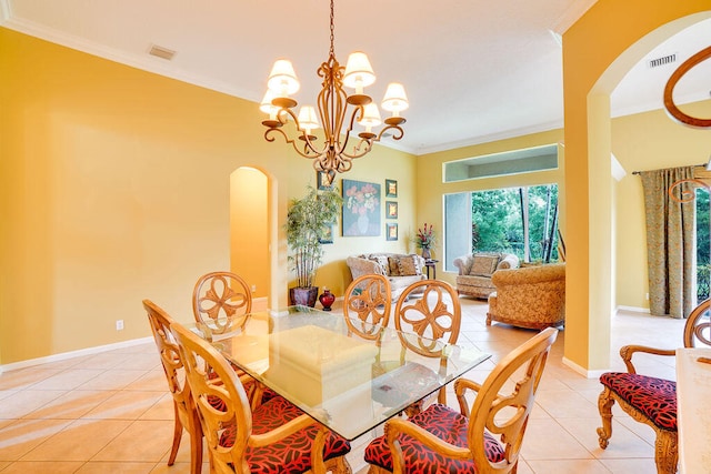 tiled dining area featuring crown molding and a chandelier