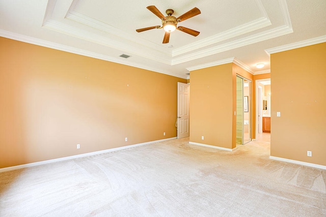 unfurnished room featuring a tray ceiling, ceiling fan, and crown molding