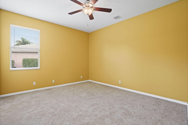 unfurnished room with a textured ceiling, carpet, and ceiling fan