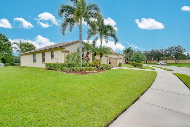 view of side of home with a lawn and a garage